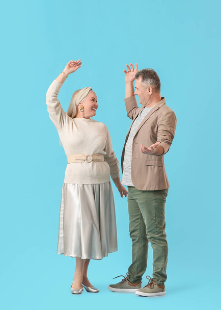 Dancing mature couple on color background - Foto, afbeelding