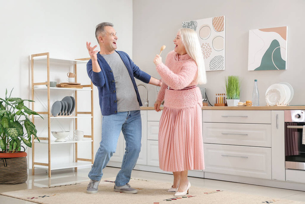 Happy mature couple dancing at home - Photo, Image