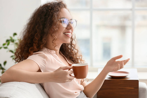 Beautiful young woman drinking coffee at home - Фото, зображення