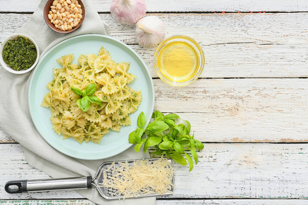 Plate with tasty pesto pasta on table - Фото, зображення