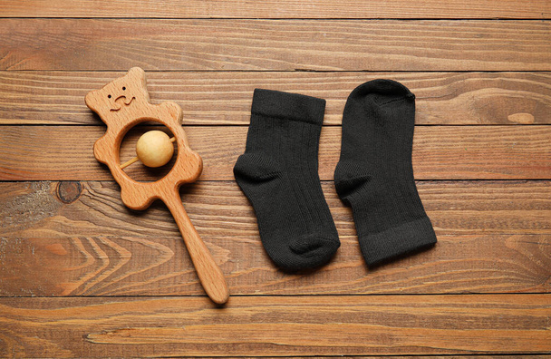Baby socks and toy on wooden background - Photo, Image