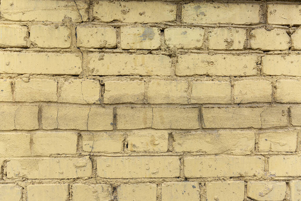 Texture of a dirty yellow brick wall. Background. Space for text - Foto, afbeelding