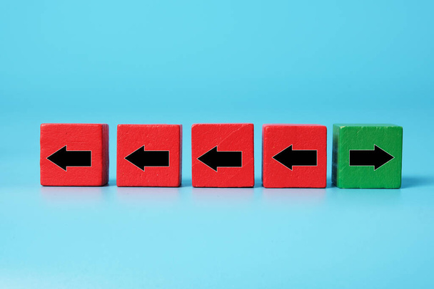 A picture of 4 red cube  to the left. 1 green cube to the right. Think out of the box, differently and brave making decision. - Photo, Image