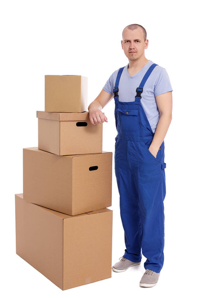 handsome loader man with heap of boxes isolated on white background - Photo, Image