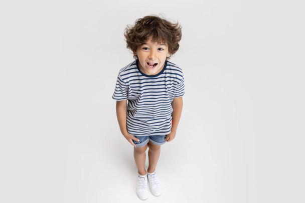 Portrait of little preschool boy posing isolated over white studio background. - Foto, Imagem
