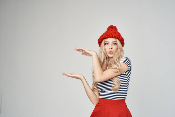 woman in a red hat gesturing with her hands Red skirt fashion - Photo, Image