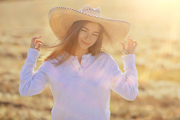 summer sunny portrait of a happy girl, female happiness sun glare straw field country style - Foto, Imagem