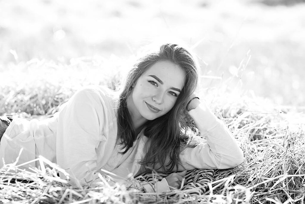 black and white portrait of a cheerful girl country style, freedom young female in a field of straw - Foto, immagini