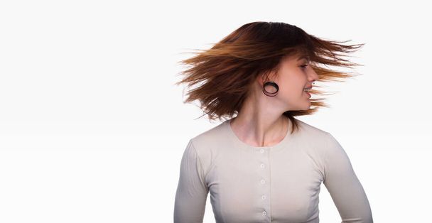 Portrait of a woman with a tunnel in her ears, and a pierced nose. White background, copy space. Woman face piercing - Photo, Image
