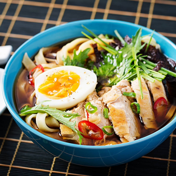 Miso soup. Japanese ramen soup with chicken, egg, nori and  nipposinica on dark background. - Photo, Image