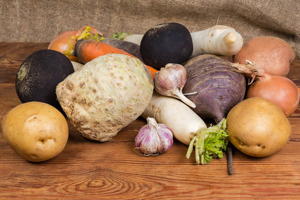 Pile of various washed raw root vegetables in their skin on the old rustic table - Photo, Image