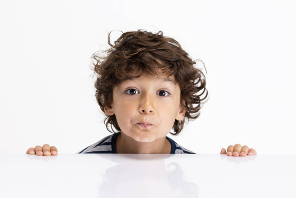 Close-up portrait of Caucasian preschool boy isolated on white studio background. Copyspace. Childhood, education, emotions concept - Zdjęcie, obraz