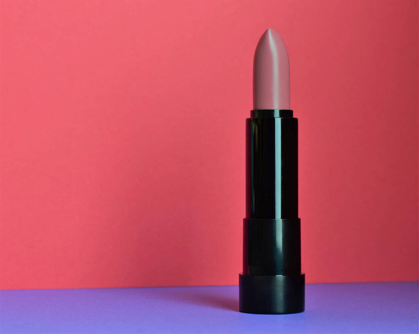 Pale pink lipstick, bicolor background outline, copy space. - Foto, imagen