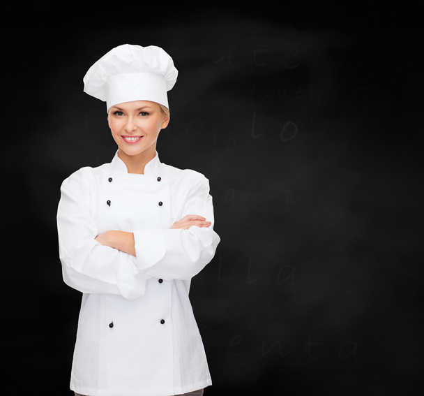 smiling female chef with crossed arms - Фото, зображення
