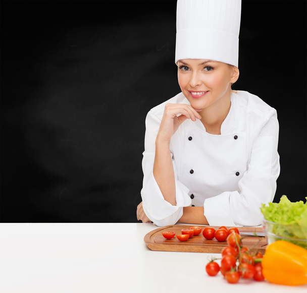 smiling female chef with vegetables - Foto, imagen