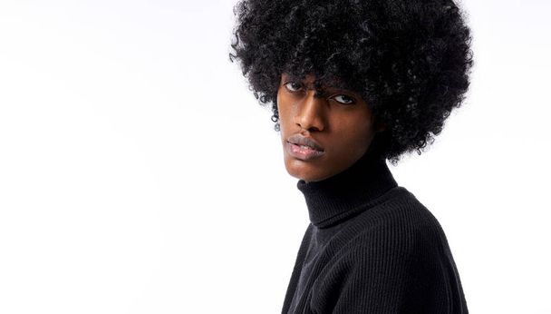 Close-up portrait of young handsome black man with stylish afro isolated on white background - 写真・画像