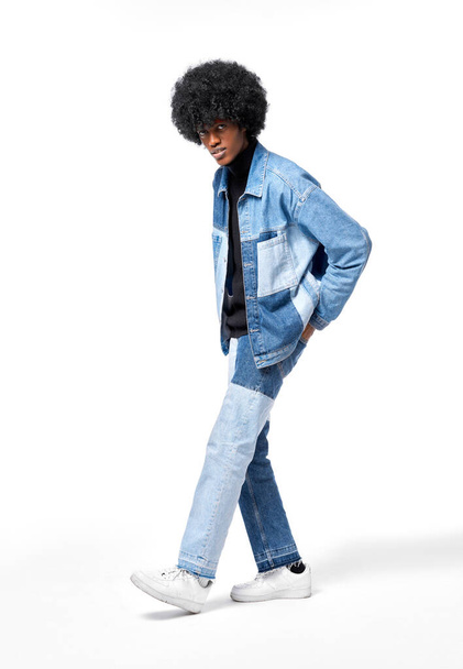 Young african american man in denim clothes isolated on white background - Фото, изображение