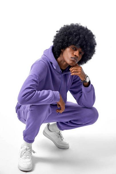 Handsome black man in tracksuit isolated on gray background - Fotó, kép