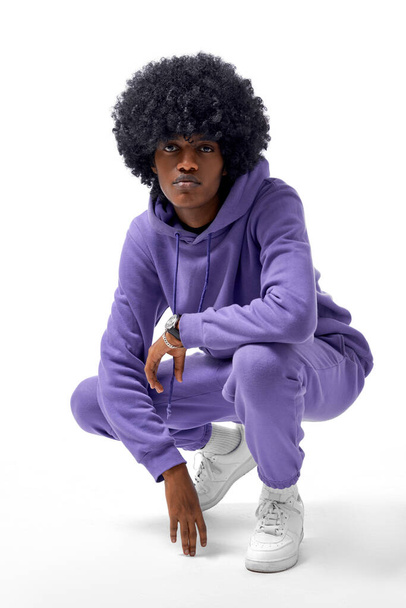 Handsome african american man wear tracksuit isolated on white background - Фото, изображение