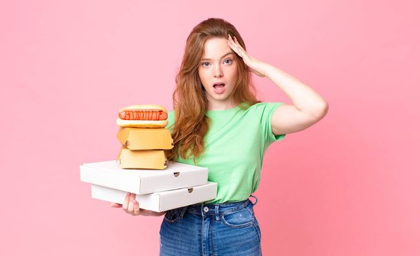 pretty red head woman holding take away fast food boxes - Photo, Image