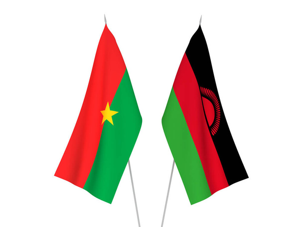 Narodowe flagi tkanin Burkina Faso i Malawi izolowane na białym tle. Ilustracja 3d renderowania. - Zdjęcie, obraz