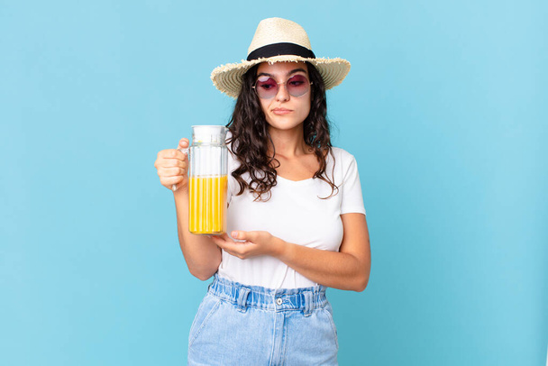 hispanic pretty woman with an orange juice - Fotoğraf, Görsel