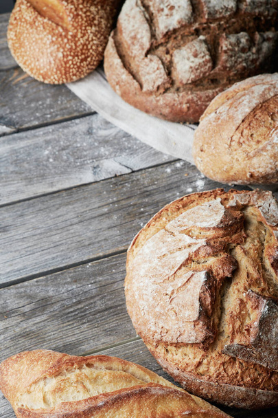 Assorted homemade gluten-free and yeast-free bread on grey wooden background. - Valokuva, kuva