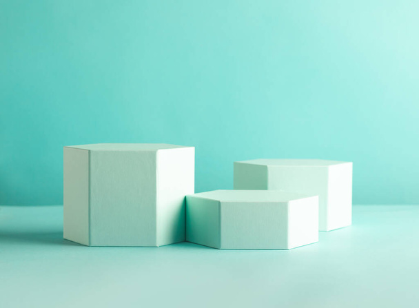 Composition of different geometric objects on pastel mint backdrop. Abstract background with hexagon shape podiums - Foto, Imagen