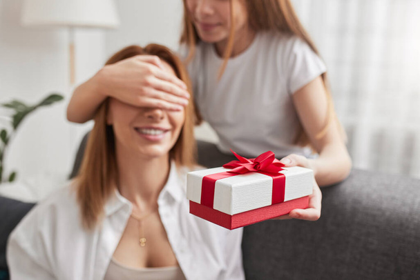 Daughter giving gift box for happy mother - Fotoğraf, Görsel