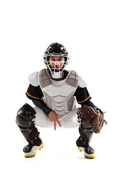 Baseball player, catcher in white sports uniform and equipment practicing isolated on a white studio background. - Фото, зображення