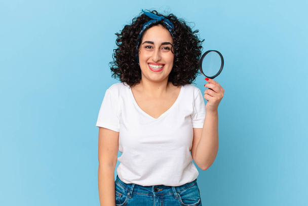 pretty arab woman with a magnifying glass - Фото, зображення