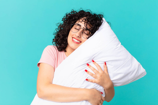 pretty arab woman wearing pajamas and with a pillow. - Фото, зображення
