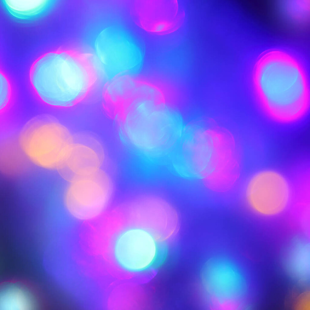glowing blurred spots of neon lights on a dark background. night fluorescent illumination - Photo, image