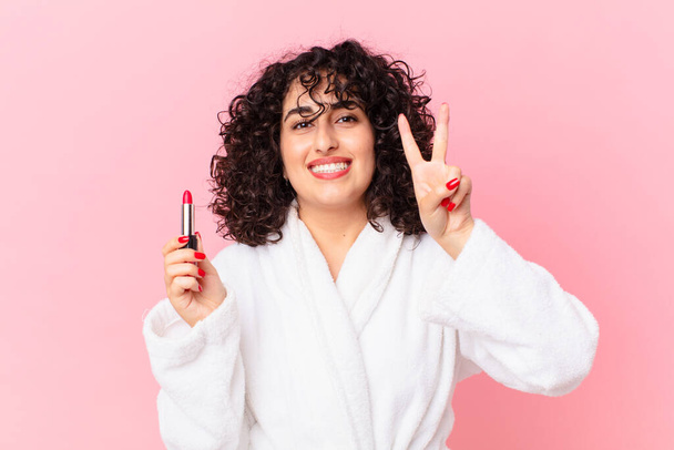 pretty arab woman wearing bathrobe and a lipstick - Fotó, kép