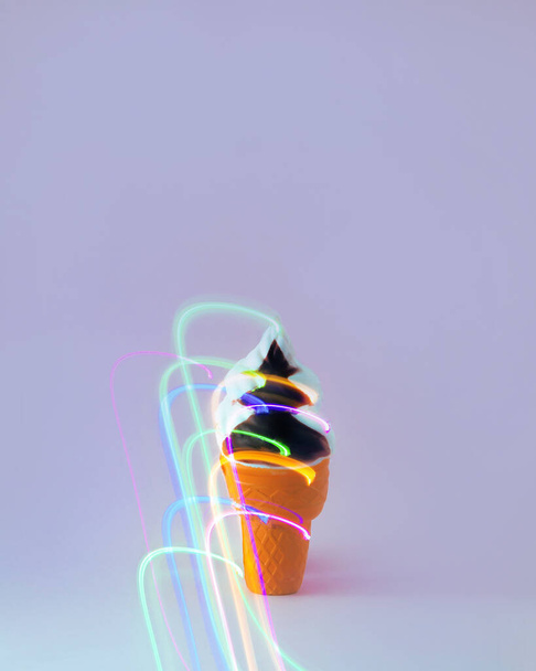 Ice cream in a cone with colorful lantern light. Summer party. Minimal composition. - Photo, Image
