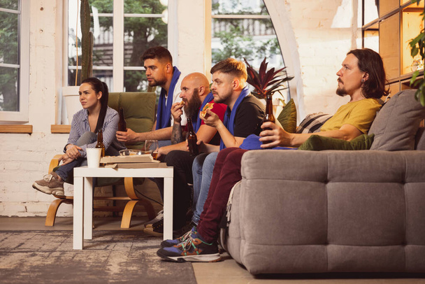 Company of friends, men and woman watching TV, sport match together. Concept of friendship, leisure activity, emotions - Φωτογραφία, εικόνα