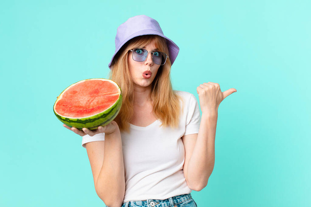 pretty red head woman and holding a water melon. summer concept - Фото, изображение