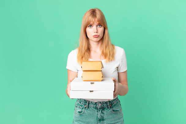 pretty red head woman holding fast food take away boxes - Foto, Imagen