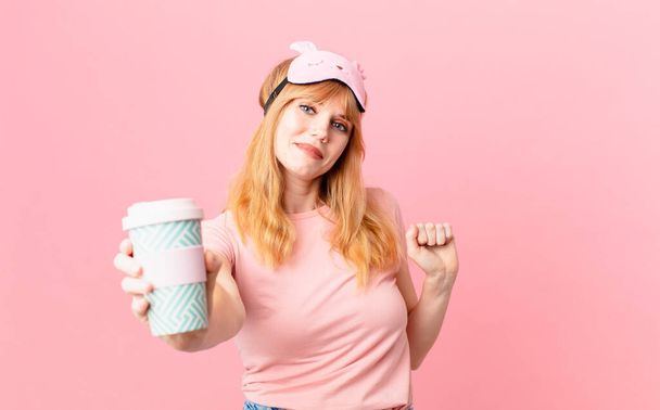 pretty red head woman wearing pajamas and having a coffee - Foto, immagini