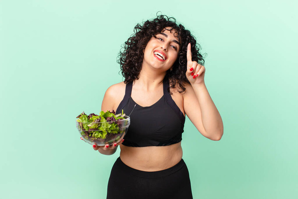 pretty arab woman feeling like a happy and excited genius after realizing an idea and holding a salad. diet concept - Foto, immagini