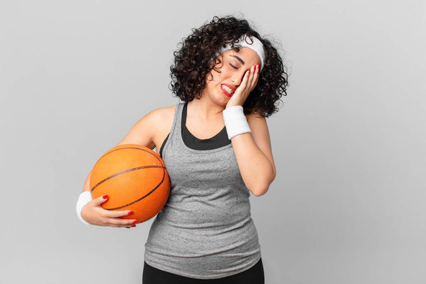 pretty arab woman feeling bored, frustrated and sleepy after a tiresome and holding a basketball ball. sport concept - Foto, afbeelding
