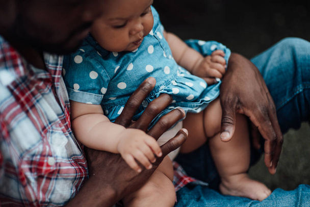 Closeup of father holding little daughter on hands  - Foto, afbeelding