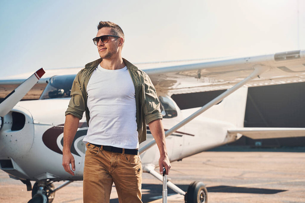 Good-looking young man standing outdoors at airport - Photo, Image