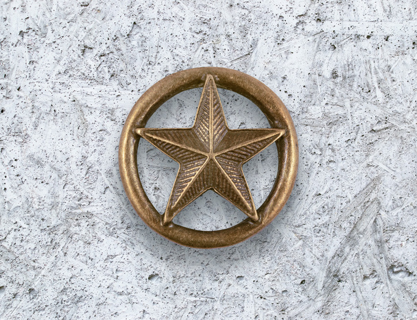 Estrella de bronce sobre fondo de cemento
 - Foto, Imagen