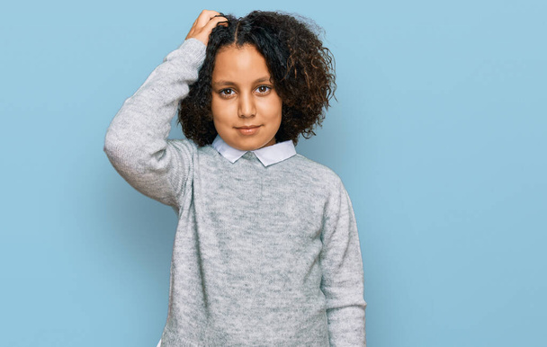 Young little girl with afro hair wearing casual clothes confuse and wonder about question. uncertain with doubt, thinking with hand on head. pensive concept.  - Fotoğraf, Görsel
