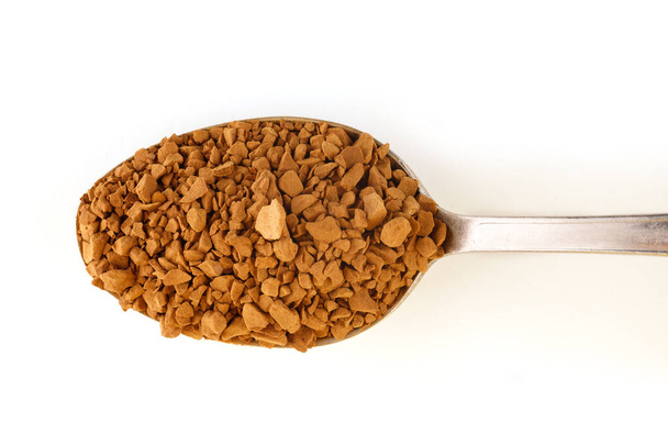 Instant coffee granules in a spoon isolate. - Photo, Image