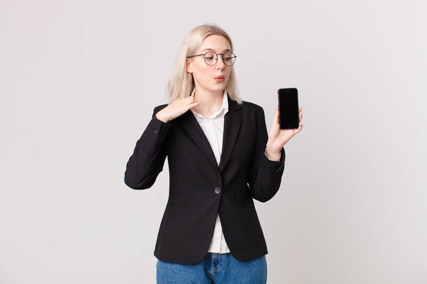 blond pretty woman feeling stressed, anxious, tired and frustrated and holding a mobile telephone - Photo, Image