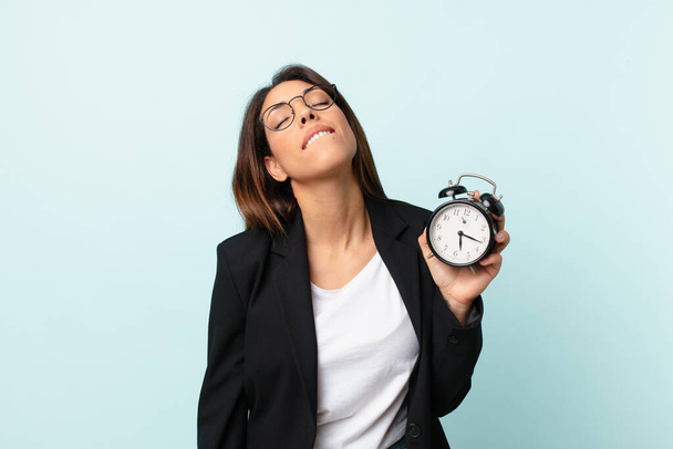 young hispanic businesswoman with an alarm clock - Photo, Image