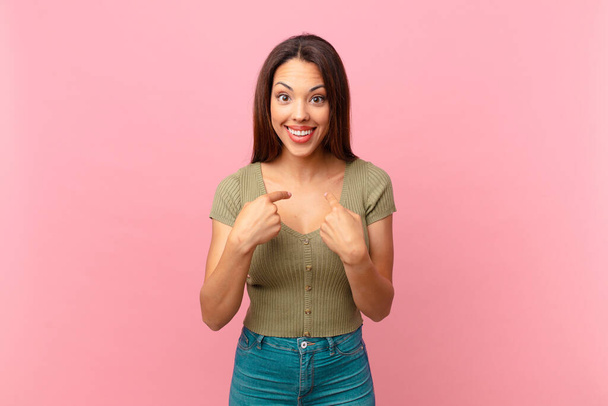 young hispanic woman feeling happy and pointing to self with an excited - Foto, afbeelding