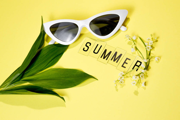 Text SUMMER from letters and field chamomiles flowers on yellow background. Greeting card Flat Lay Copy space Concept Hello summer, summertime - Фото, зображення